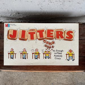 May include: A vintage "Jitters" word game box. The title is in large, red, block letters. The box art features cartoon figures at desks, with the text "It's Enough to Make Anybody Crazy."