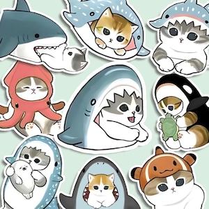 May include: A set of ten colorful stickers featuring cute cartoon cats wearing various animal costumes, including sharks, octopuses, and orcas. The stickers are perfect for adding a touch of whimsy to laptops, water bottles, or journals.