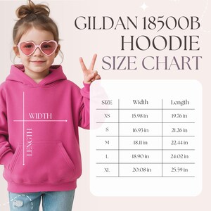 May include: A young person wearing a pink hoodie, with a size chart for the Gildan 18500B hoodie. The chart shows sizes XS to XL, with width and length measurements in inches.
