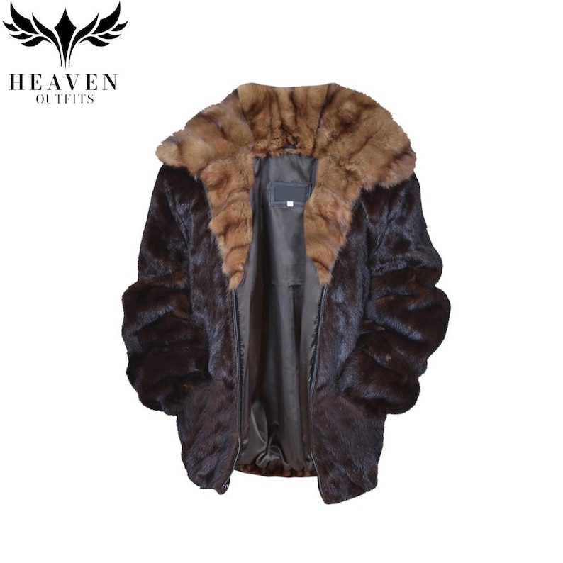 May include: A dark brown fur coat with a lighter brown fur collar. The coat has a zipper closure and a dark lining. The logo "HEAVEN OUTFITS" is in the upper left corner.
