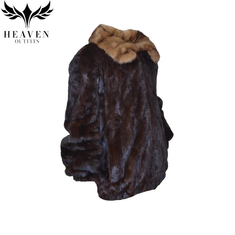 May include: A dark brown fur coat with a light brown collar. The coat has a plush, textured appearance and is likely made of animal fur. The logo "HEAVEN OUTFITS" is visible in the upper left corner.