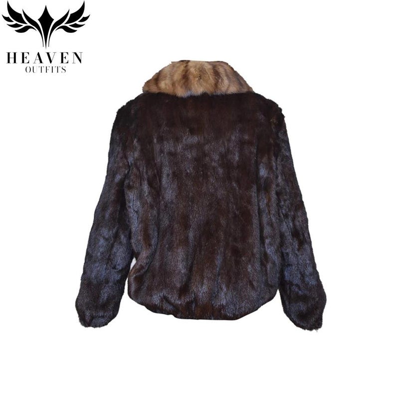May include: A dark brown fur jacket with a light brown fur collar. The jacket has long sleeves and a smooth, luxurious texture. The back view of the jacket is shown against a white background. The brand logo "HEAVEN OUTFITS" is in the top left corner.