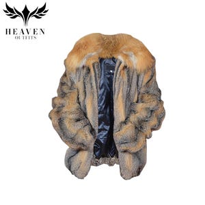 May include: A luxurious fur coat with a large, orange-toned collar and a dark blue interior. The coat features a mix of brown, gray, and orange fur, with a zipper closure. The logo "HEAVEN OUTFITS" is in the top left corner.