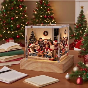 May include: A clear, illuminated Christmas-themed photo block featuring a family gathering. The block sits on a wooden base, with Christmas trees and decorations in the background. The family is gathered around a table, wearing festive sweaters and Santa hats.