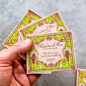 May include: Three vintage boxes of "Poudre de Riz Superieure" face powder by Parfumerie Nogara, Grasse Paris. The boxes are pink and white with green and white floral designs.