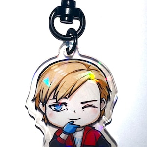 May include: A holographic anime character keychain with a black heart-shaped clip. The character is a young man with blond hair, blue eyes, and a red and black jacket. He is winking and has a mischievous expression.
