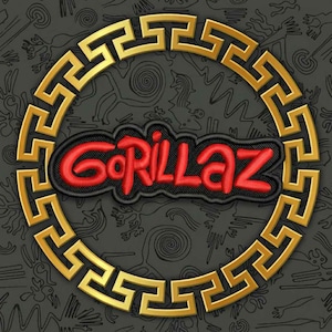 May include: Embroidered patch featuring the word "Gorillaz" in red, stylized lettering on a black background. The patch is surrounded by a gold-colored, geometric border, set against a dark gray patterned backdrop.
