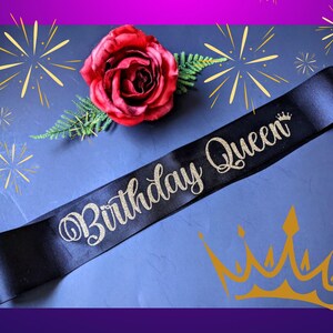 May include: Black satin sash with gold glitter lettering that reads "Birthday Queen".