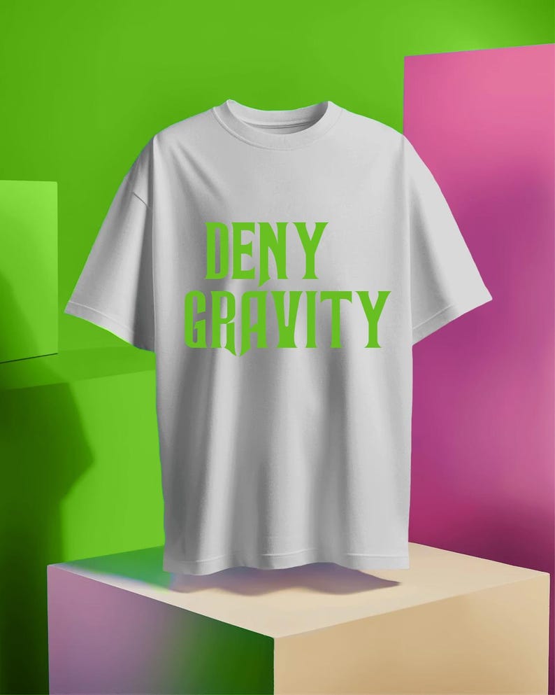 May include: White t-shirt with the text "DENY GRAVITY" printed in green.