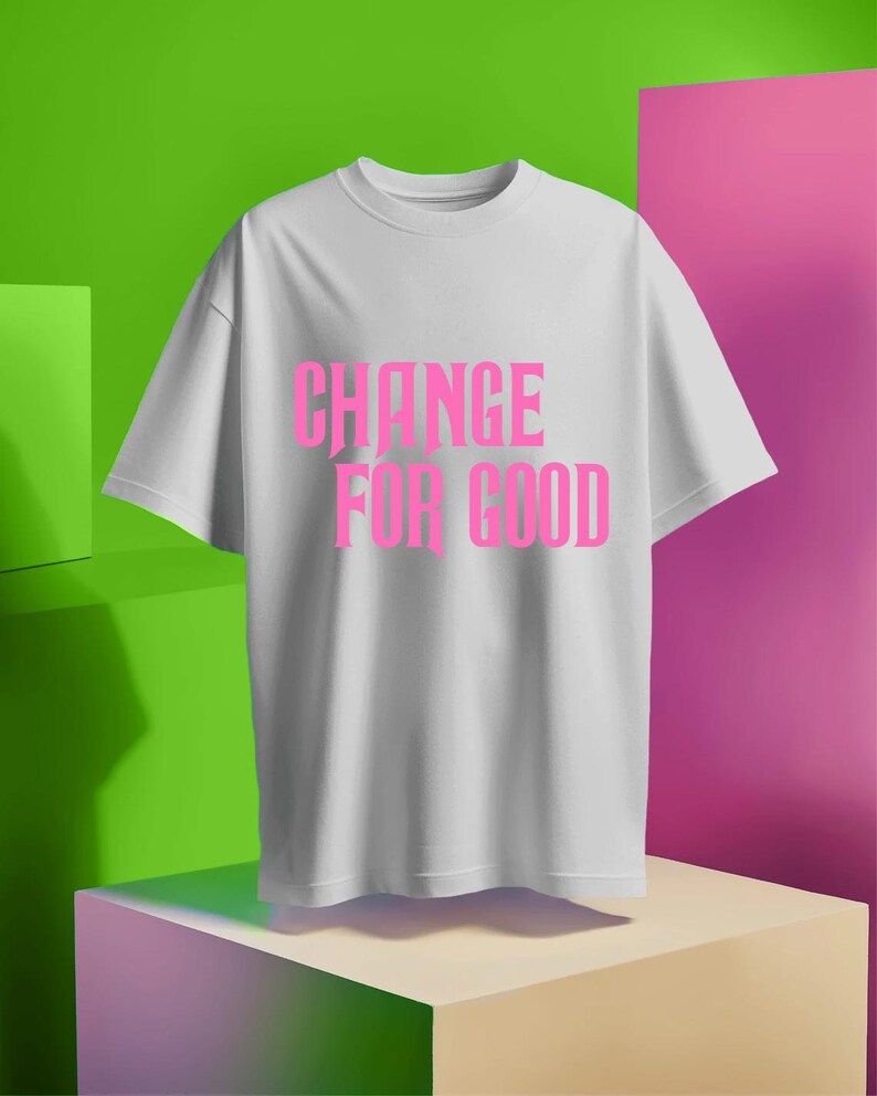 May include: White t-shirt with the text "CHANGE FOR GOOD" printed in pink.