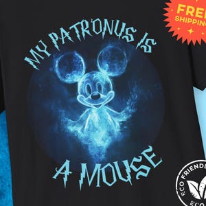 May include: A black t-shirt with a blue and white graphic of Mickey Mouse as a Patronus. The text "My Patronus is a Mouse" is printed in blue on the shirt.