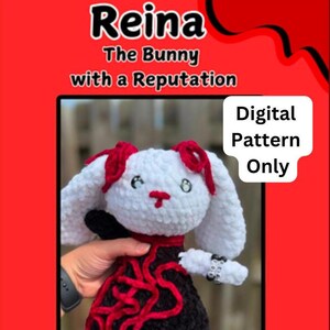 May include: A crochet pattern for a white bunny wearing a black and red dress. The pattern is called "Reina: The Bunny with a Reputation" and is available as a digital download only. The pattern is created by TeacherMeetsCrochet.