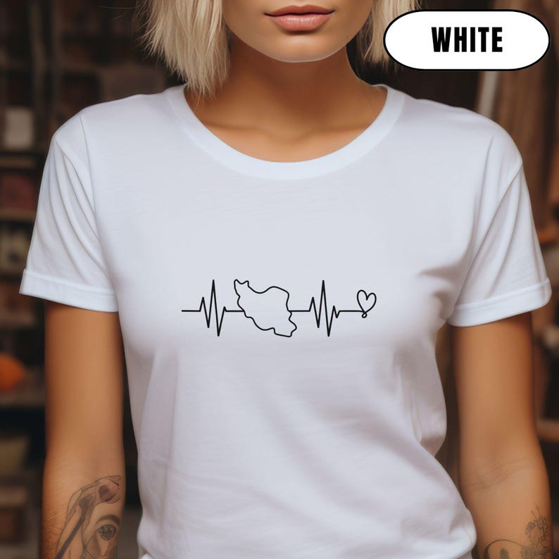 May include: White t-shirt with a black graphic. The design shows a heartbeat line, a country outline, and a heart symbol. The word "WHITE" is in a white oval at the top of the image.
