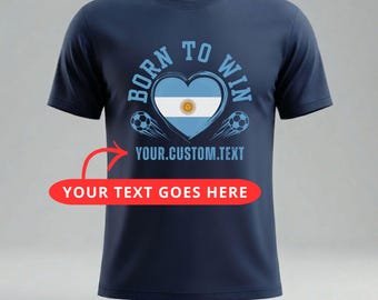 May include: Navy blue t-shirt with a heart-shaped design featuring the Argentinian flag and the words "BORN TO WIN". Includes soccer ball graphics and space for custom text.