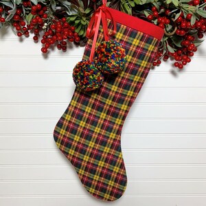 Tartan Plaid Flannel Christmas Stocking with Rainbow Pom Poms for a Festive and Whimsical Holiday Display