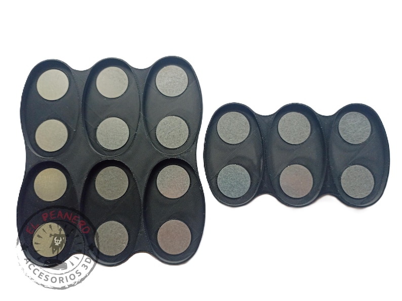 May include: Two black plastic trays with multiple circular depressions. The trays are designed to hold small round objects, such as paint pots or other small containers. The trays are made of a durable plastic and are easy to clean.
