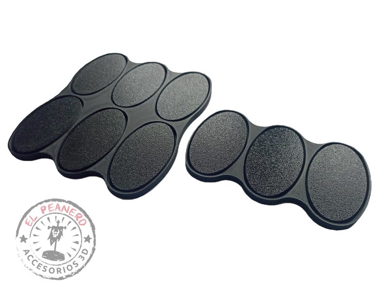 May include: Two sets of black oval-shaped paint trays. The larger set has six trays and the smaller set has three trays. Both sets are made of a textured material.
