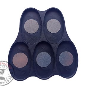 May include: Black plastic tray with six oval-shaped compartments. Each compartment has a circular indentation.