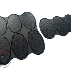 May include: Black plastic paint tray with six oval-shaped wells. The tray is designed to hold small amounts of paint for miniature painting.