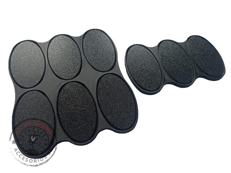 May include: Black plastic paint tray with six oval-shaped wells. The tray is designed to hold small amounts of paint for miniature painting.