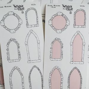 May include: Two sheets of sticker paper featuring a variety of stone window designs. The designs are black and white with a pink outline. The sticker sheets are labelled "Stone Windows" and "Stone Windows - Pink".