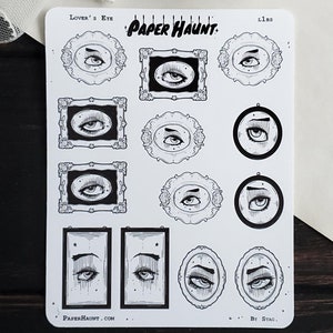 May include: A sheet of stickers featuring various black and white illustrations of eyes in different frames. The stickers are labeled "Lover's Eye" and "Paper Haunt."