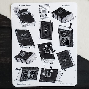 May include: A sheet of stickers featuring black and white illustrations of vintage books with titles like "The Haunted Library", "Eldritch Tome", and "Mycology". The stickers are on a white background and have a whimsical, gothic aesthetic.