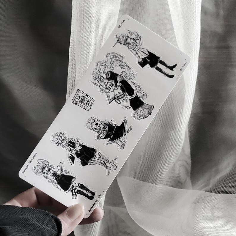 May include: A sheet of black and white stickers featuring illustrations of characters in various poses. The stickers include the text "The Only Ballad" and "Premium Size".
