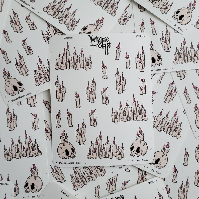 May include: A sheet of stickers featuring a variety of candles and skulls. The stickers are white with black outlines and pink accents. The text "Vampire's Crypt" and "Candle" are visible on the stickers.