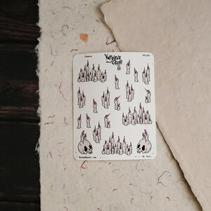 May include: A sheet of stickers featuring various illustrations of candles with flames. The stickers are white with black outlines and red flames. The sheet also includes two skull illustrations with candles on top. The text "Yumeiro Craft" is printed at the top of the sheet.