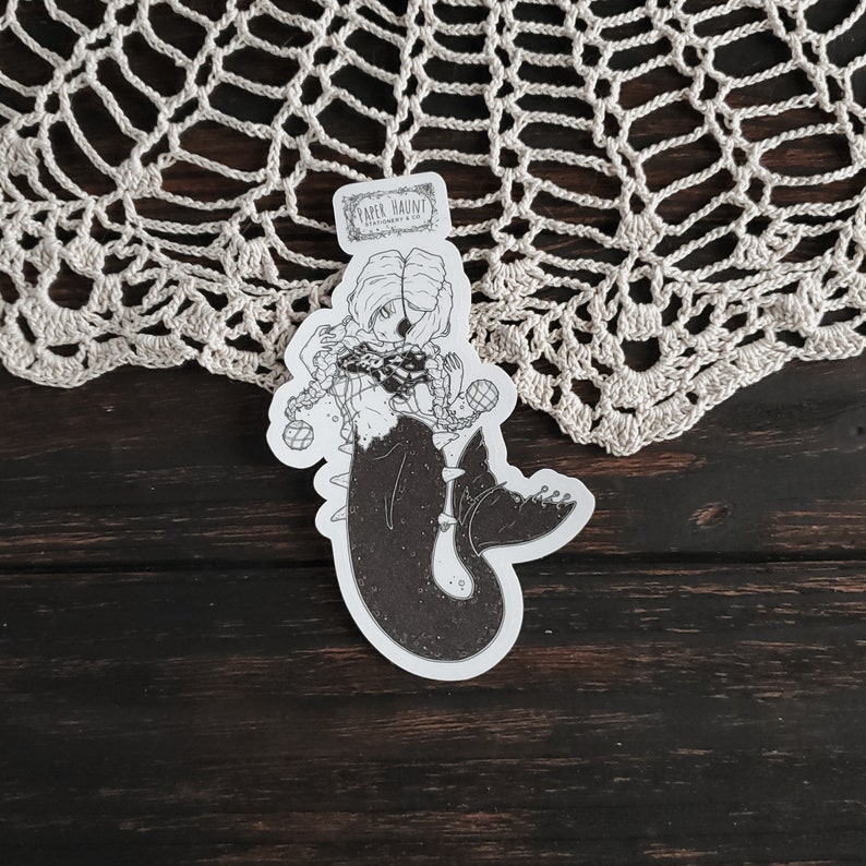 Gothic pirate mermaid sticker by artist White stag for Paper Haunt Stationery & Co on a doily
