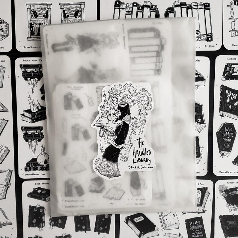 May include: A sticker sheet with a black and white illustration of a woman reading a book. The sticker sheet is titled "The Haunted Library Sticker Collection".
