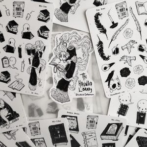 May include: A set of black and white stickers featuring illustrations of books, a skull, a raven, and a woman reading a book. The stickers are part of a collection called "The Haunted Library Sticker Collection".