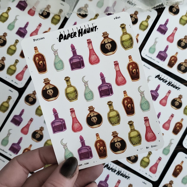 May include: A sheet of colorful potion bottle stickers with a white background. The stickers feature various colors and designs, including purple, green, red, and blue. The stickers are labeled "Potions" and "Paper Haunt."