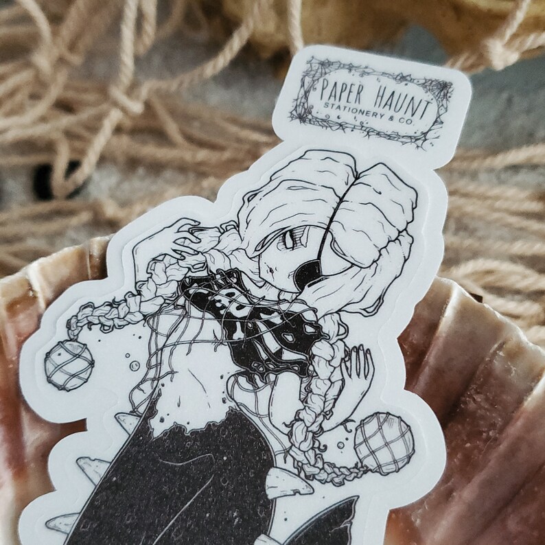 Close up of Gothic pirate mermaid sticker by artist White stag for Paper Haunt Stationery & Co in a seashell.