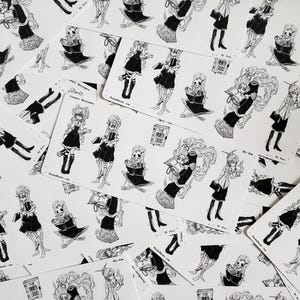 May include: A set of black and white stickers featuring a skeleton girl in various poses. The stickers are on a white background and feature the text "The Haunted Library".