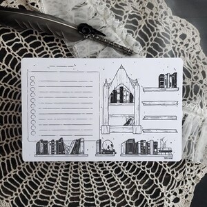 Op de afbeelding: Een zwart-witte printbare plannerpagina met een to-dolijst, een boekenkast met boeken en een schedel. De tekst "PAPER HUNT" staat onderaan de pagina.