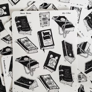 May include: A set of 10 black and white stickers featuring illustrations of books with spooky titles like "Who Moved My Bones?" and "Ghost Stories". The stickers are printed on white paper and have a glossy finish.