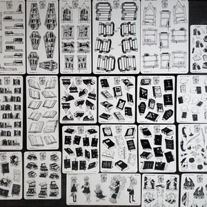 May include: A sheet of black and white stickers featuring various illustrations of books, shelves, and other book-related imagery. The stickers are designed for use in planners, journals, and other creative projects.