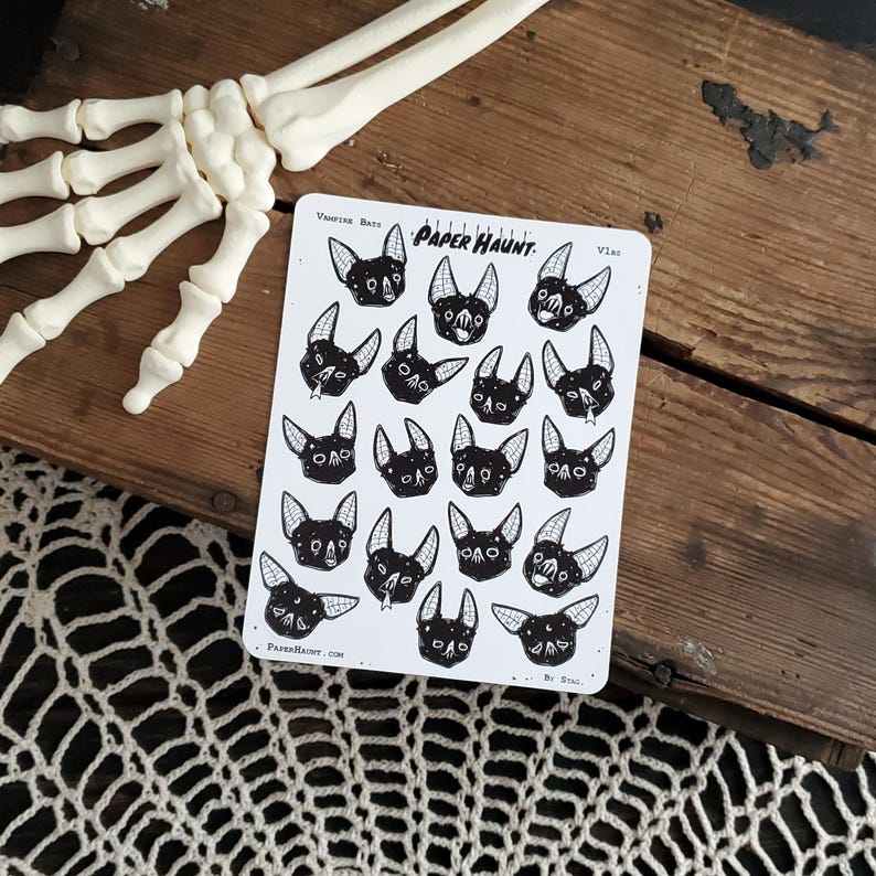 May include: A sheet of stickers featuring 18 black and white illustrations of vampire bats with various expressions. The stickers are on a white background with the text "Vampire Bats" and "PAPER HAUNT." at the top. The text "By Snail" appears at the bottom.
