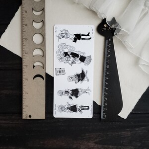 May include: A set of five black and white illustrations of women in various poses. Each illustration features a woman with long hair, wearing a dress and holding a book. The illustrations are printed on a white background.