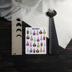 May include: A sheet of 24 colorful potion bottle stickers with a skull and crossbones design. The stickers are on a white background with the text "Paper Haunt" in black.