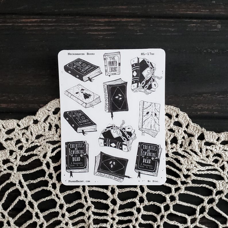 May include: A sheet of black and white stickers featuring illustrations of books with spooky titles like "The Haunted Library", "All The Dead We Remember", and "110 Rules of Summoning the Dead".
