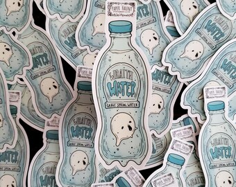 May include: A stack of blue and white stickers featuring a ghost and a bottle of water labelled "Wraith Water Grave Spring Water".