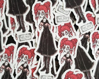 May include: A collection of stickers featuring a cartoon girl with red hair wearing a black dress and white boots. The stickers have a white background and feature the text "Paper Haunt Stationery & Co."