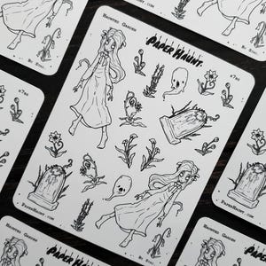 May include: A sheet of black and white stickers featuring a haunted garden theme. The stickers include a ghost, a tombstone, flowers, and two girls in dresses. The text "PAPER HAUNT" is printed on the sheet.