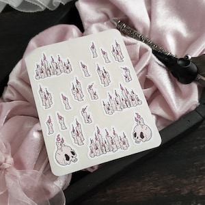 May include: A sheet of stickers featuring various illustrations of candles and skulls. The candles are depicted in a variety of sizes and shapes, with some featuring flames and others without. The skulls are depicted in a simple, cartoon style.