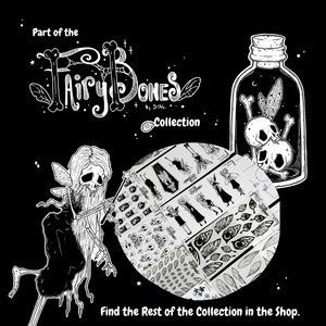 May include: Black and white illustration featuring the "Fairy Bones Collection." The image includes a skeletal fairy with a wand, a jar with skulls, and a circular display of stickers with gothic and fantasy designs. Text reads "Find the Rest of the Collection in the Shop."