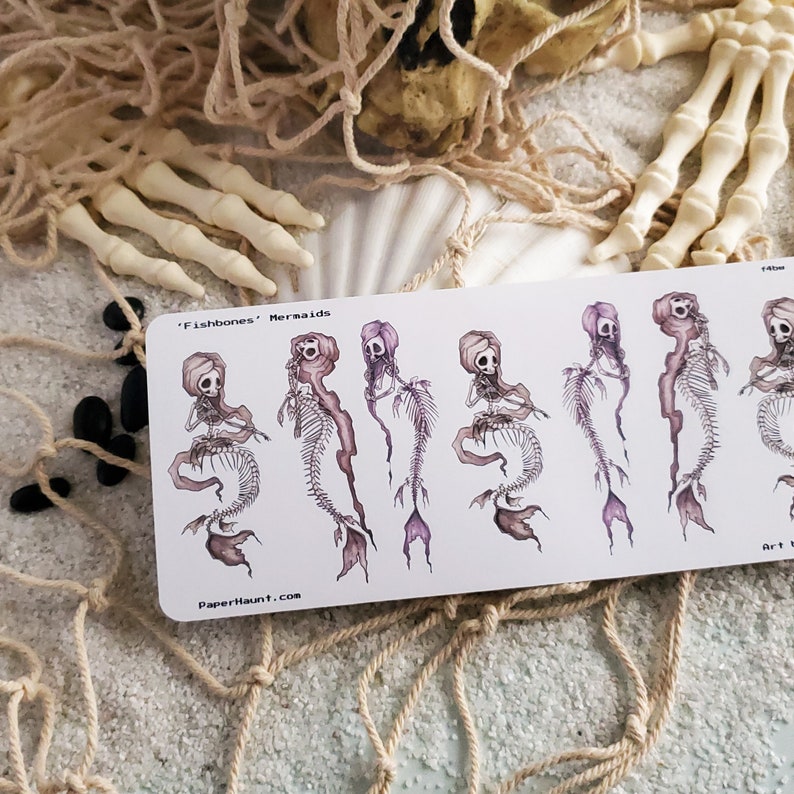 Fishbones mermaid skeleton sticker sheet in the sand on the beach