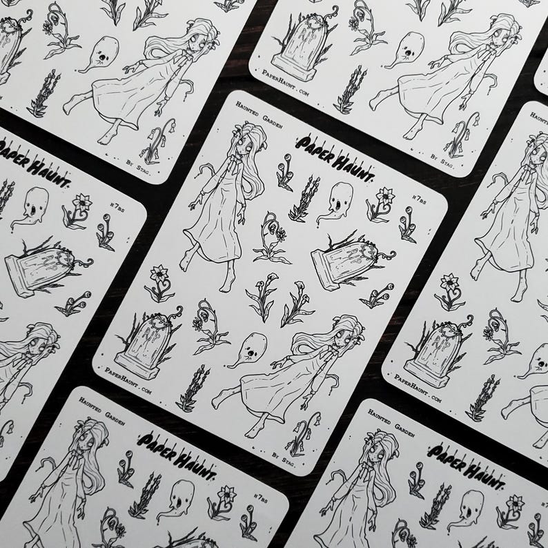 May include: A sheet of black and white stickers featuring a spooky haunted garden theme. The stickers include a ghost, a tombstone, flowers, and a girl in a white dress. The sheet is labeled "Paper Haunt" and "Haunted Garden".